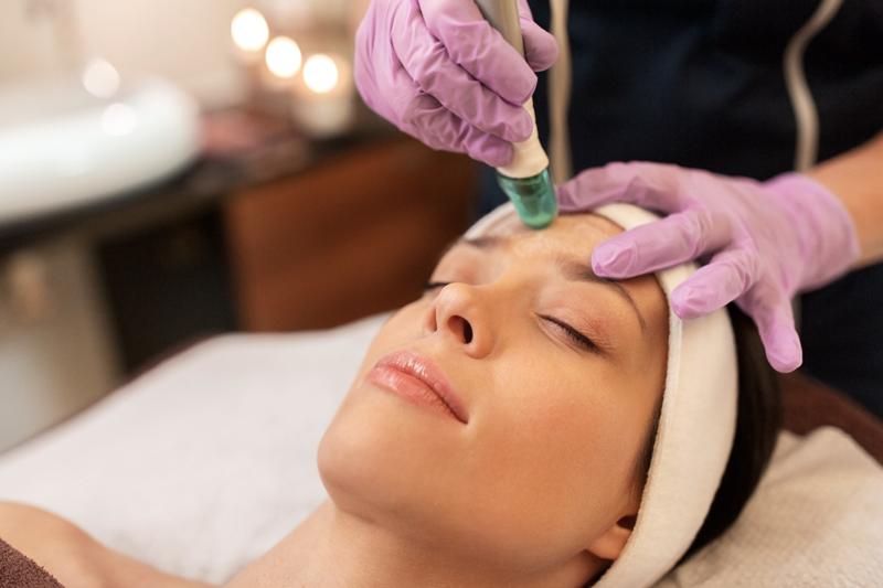 woman having microdermabrasion facial treatment